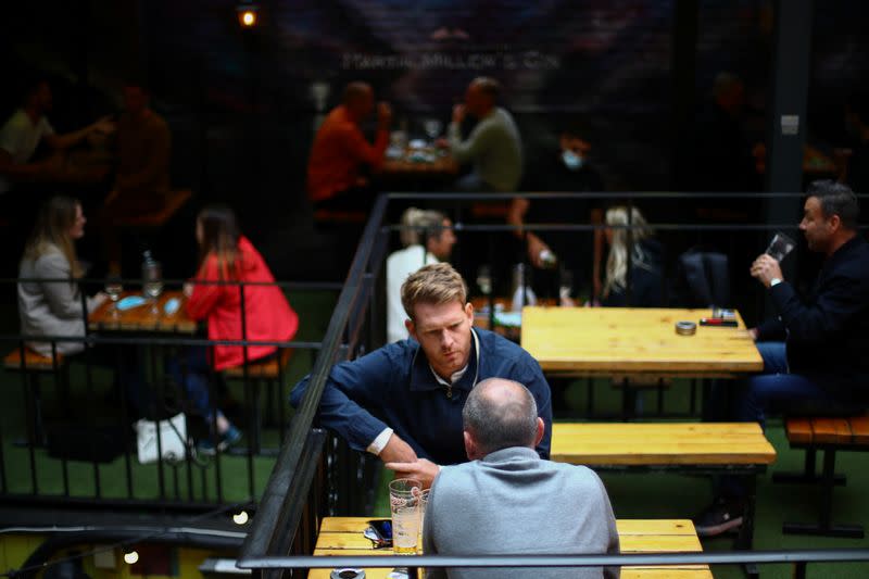 People sit in a pub in London Bridge, amid the outbreak of the coronavirus disease (COVID-19) in London