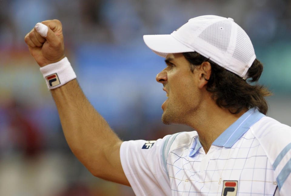 Argentina's Eduardo Schwank celebrates after winning the first set  of the Davis Cup final doubles match with teammate David Nalbandian (L) against Spain's Feliciano Lopez  and Fernando Verdasco at La Cartuja Olympic stadium in Sevilla on December 3, 2011.   AFP PHOTO / CRISTINA QUICLER (Photo credit should read CRISTINA QUICLER/AFP/Getty Images)