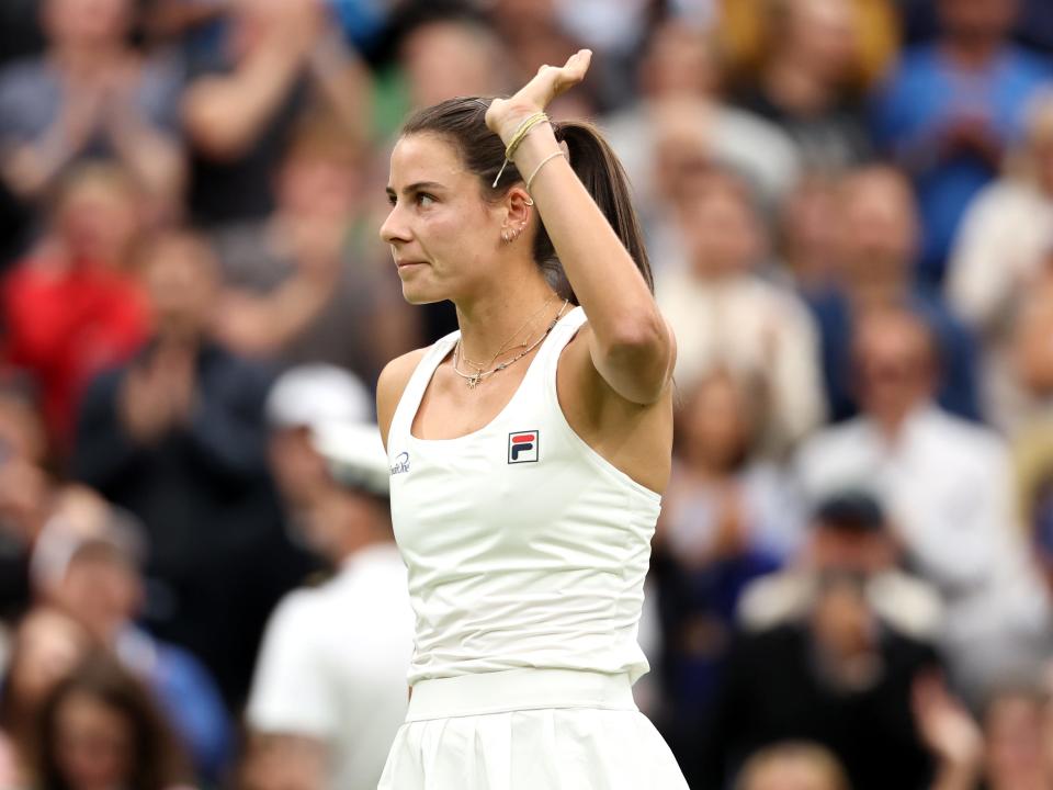 Navarro waves to the crowd after defeating Naomi Osaka in round two of Wimbledon 2024.