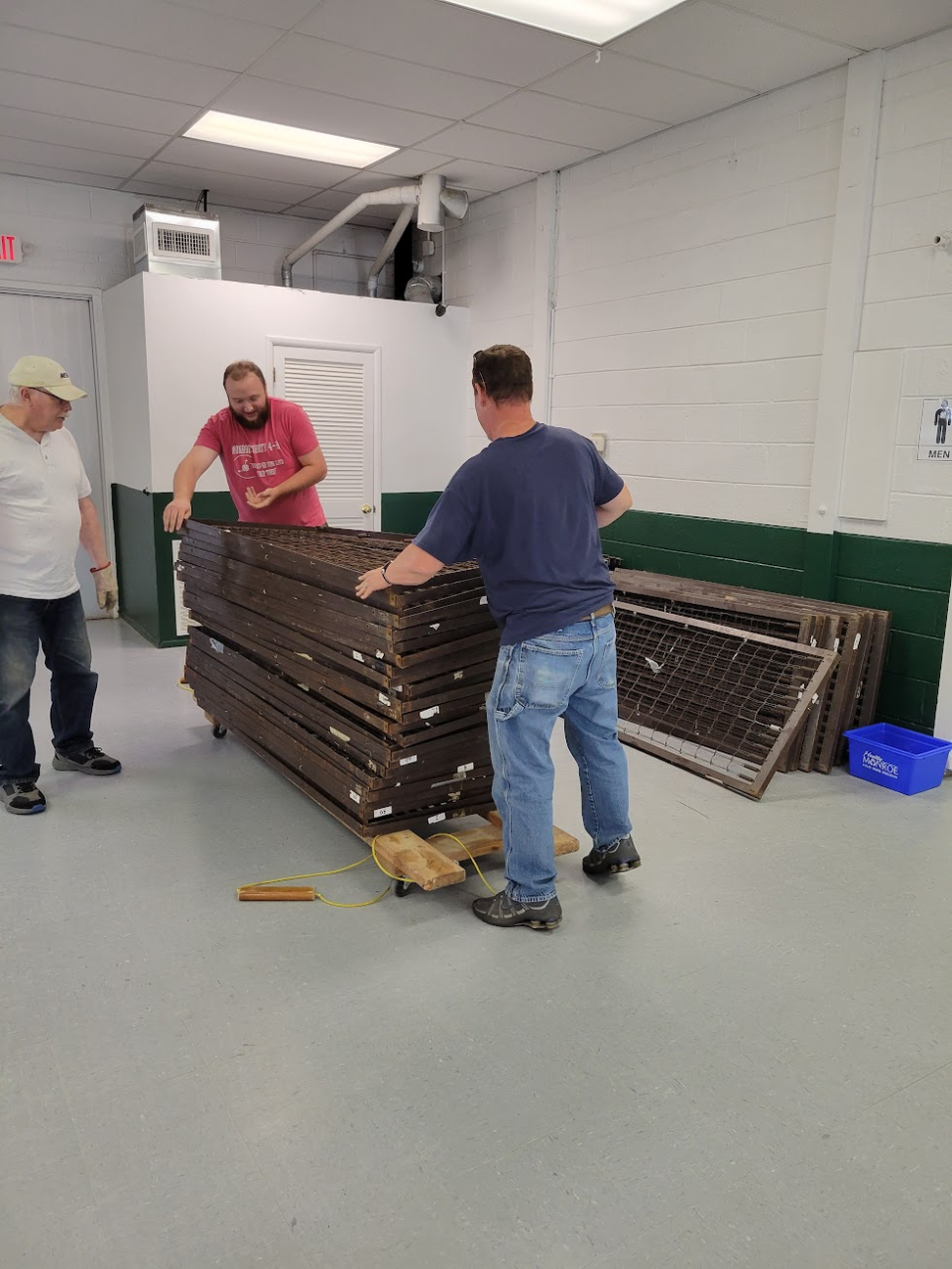 Gary Davis, left, Ben Kittendorf and Scott Salyers, representatives from Monroe County 4-H and Rotary District 6600’s MESA, prepare to ship bunk beds and cots to help Ukrainian refugees and medical staff in Belize.