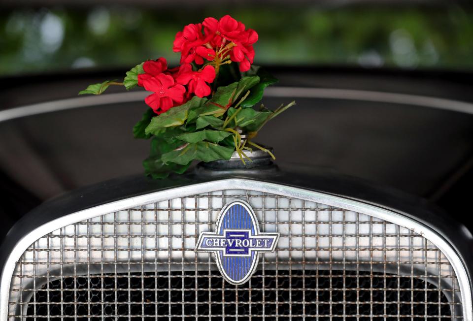 Artificial flowers are attached to the radiator cap of Caines Flowers' 1931 Chevrolet Woody.