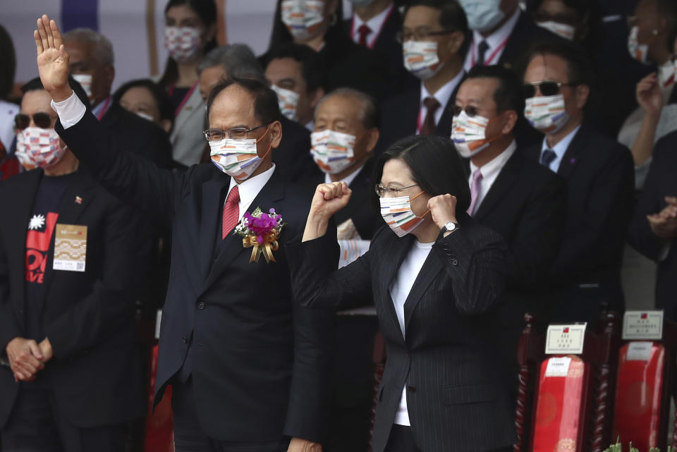 Taiwan's President Tsai Ing-wen, right, and Yu Shyi-kun, speaker of the Legislative Yuan, cheer with audience during National Day celebrations in front of the Presidential Building in Taipei, Taiwan, Saturday, Oct. 10, 2020. President Tsai said Saturday she has hopes for less tensions with China and in the region if Beijing will listen to Taipei’s concerns, alter its approach and restart dialogue with the self-ruled island democracy. (AP Photo/Chiang Ying-ying)