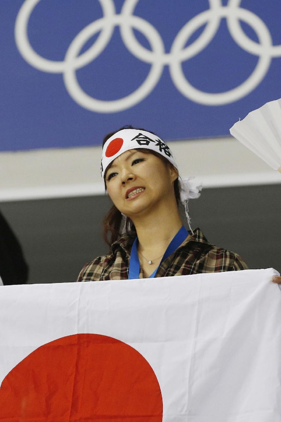 A Japanese fan reacts to the 4-0 loss to Germany during the 2014 Winter Olympics women's ice hockey game at Shayba Arena, Thursday, Feb. 13, 2014, in Sochi, Russia. (AP Photo/Petr David Josek)