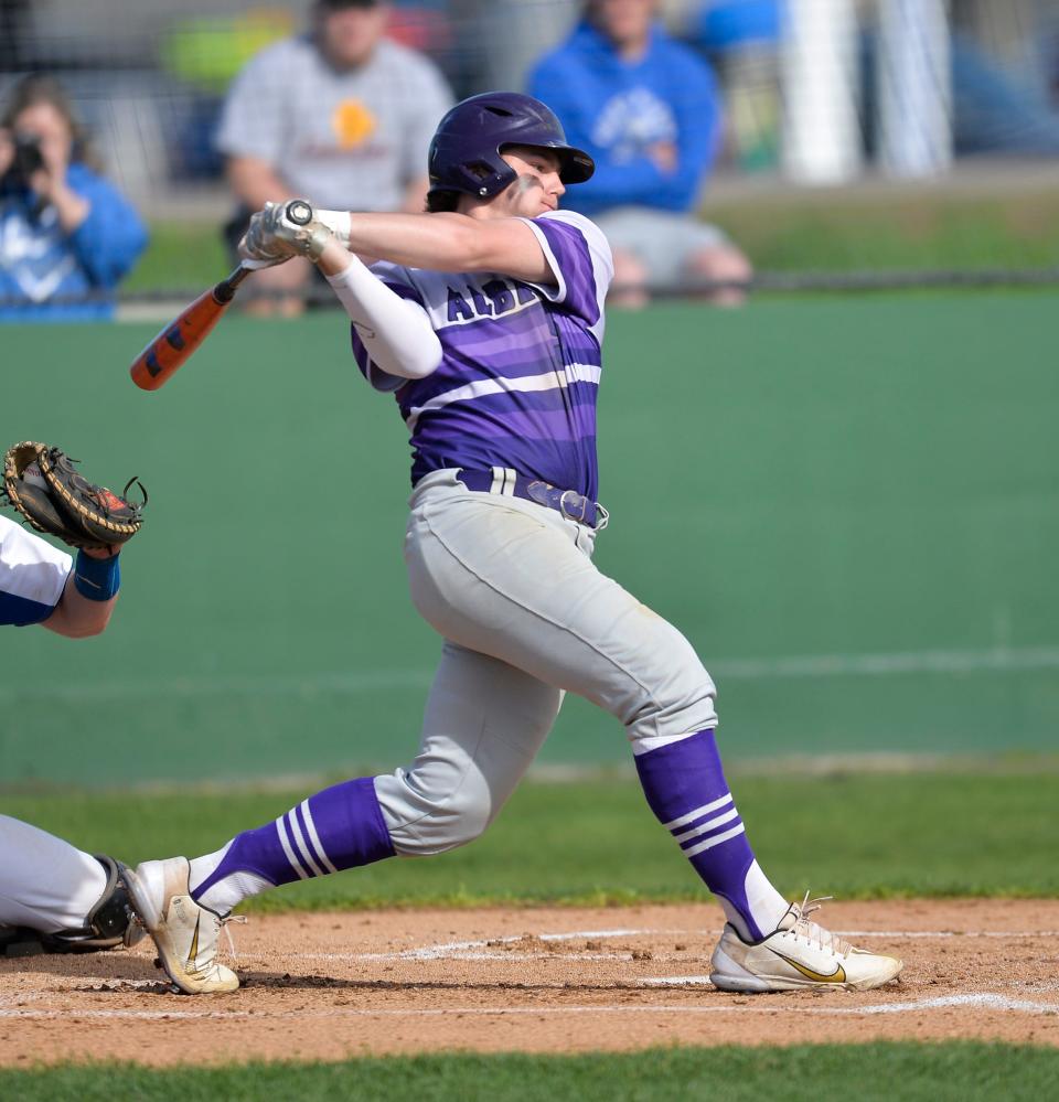 Albany's Caden Sand follows through on his swing against Foley on Friday, May 13, 2022, at Central Park in Avon. 