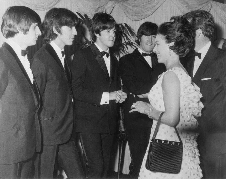 (Original Caption) Princess Margaret Meets Beatles, M.B.E. London: H.R.H. Princess Margaret, Countess of Snowdon and the Earl of Snowdon (hidden right), last night attended the Royal World Premiere of the Beatles new movie, Help!, which was held at the London Pavilion in aid of the Dockland Settlements and Variety's Charity Fund for Children. Before the film, the Beatles were presented to the Princess. Photo shows, Princess Margaret with the Beatles, from left to right, Ringo Starr, George Harrison, Paul McCartney and John Lennon.