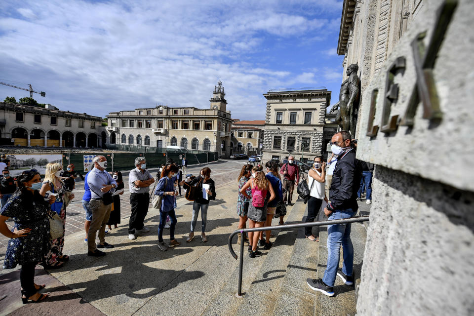 Members of Noi Denunceremo (We will denounce) group arrive at Bergamo's court, Italy, Monday, July 13, 2020. Lawyers for the Noi Denunceremo (We Will Denounce) Facebook group and an affiliated non-profit committee are filing 100 new cases Monday with Bergamo prosecutors investigating the outbreak, on top of 50 complaints lodged last month. ( Claudio Furlan/LaPresse via AP)