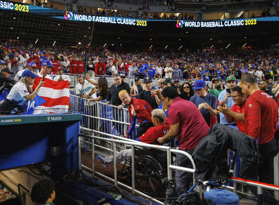 Puerto Rico pitcher Edwin Diaz (39) leaves in a wheelchair after a World Baseball Classic game against the Dominican Republic, Wednesday, March 15, 2023, in Miami. (David Santiago/Miami Herald via AP)