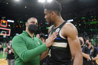 Boston Celtics head coach Ime Udoka, left, greets Milwaukee Bucks forward Giannis Antetokounmpo, right, following Game 7 of an NBA basketball Eastern Conference semifinals playoff series, Sunday, May 15, 2022, in Boston. The Celtics won 109-81. (AP Photo/Steven Senne)