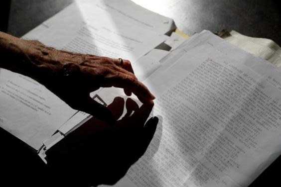 Paterno goes over his study notes at his desk (Reuters/Guglielmo Mangiapane)