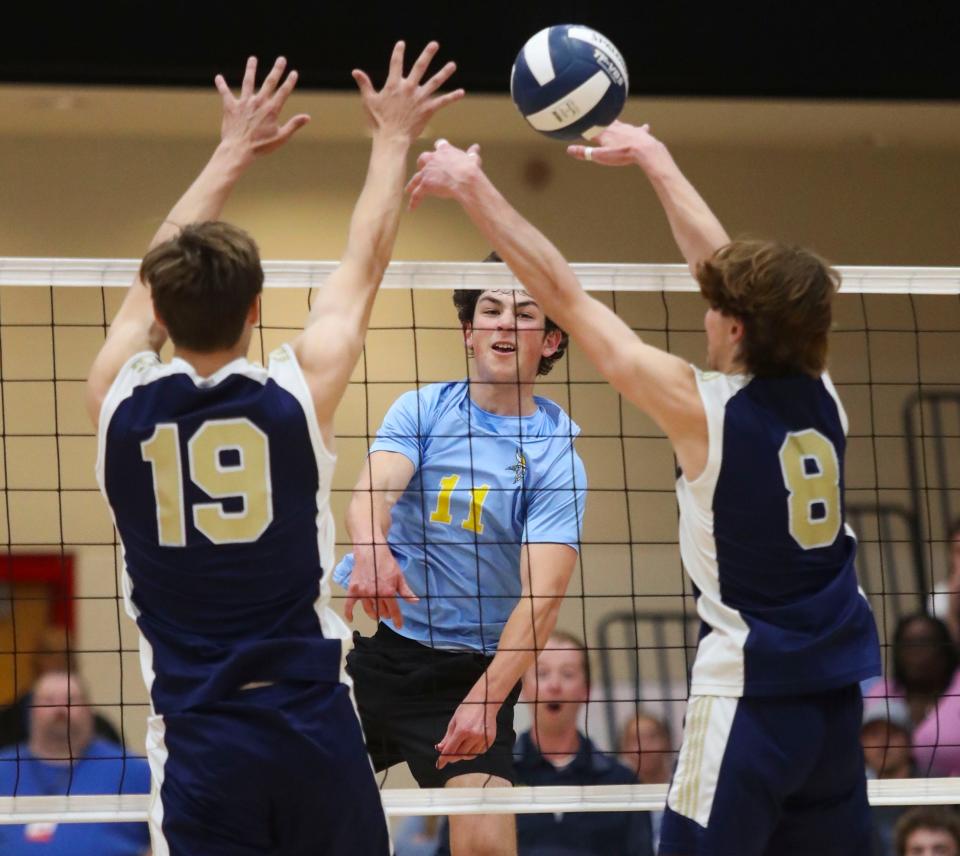 Cape Henlopen's Brady Lamb blasts a kill attempt against Salesianum's Connor Brown (left) and Cody Popp int eh secong game of Cape Henlopen's 3-0 win for the first DIAA state title earned in boys volleyball, Tuesday, May 23, 2023 at Smyrna High School.