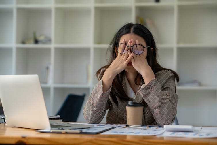 Stressed woman holding her head