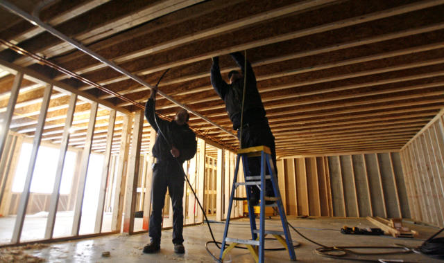 Jeff Rose, right, and Wayne Green of Gillespie Fuels, install a heating system in a new home in Barre, Vt., Wednesday, Dec. 16, 2009. Construction of new homes, helped by better weather, rebounded in November following a setback in the previous month. (AP Photo/Toby Talbot)