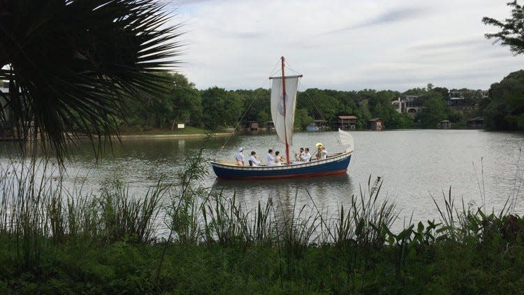 At an Art Dinner for The Contemporary Austin, a festive boat passes not far from the site of Cypress Springs in the lagoon on the Laguna Gloria grounds. The lagoon was formed when Lake McDonald was impounded. The springs were located, according to most recent research, just outside the lagoon at a spot now submerged under the lake.