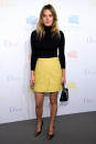 <p>Camille Rowe kept it simple in a black turtleneck, yellow miniskirt and heels from Dior. </p>