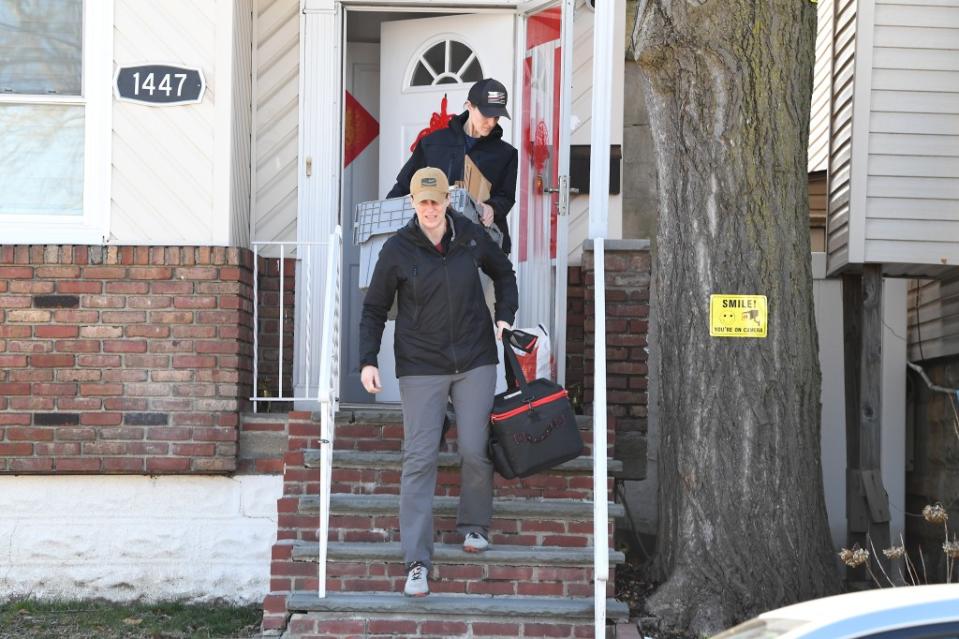 Federal agents carry documents from a raid of Winnie Greco’s home in the Bronx Thursday. Greco, a key aide to Mayor Adams, is being investigated by the city’s Department of Investigation. Matthew McDermott
