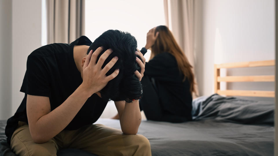 A couple with relationship problems sitting on a bed. (Photo: Getty Images)