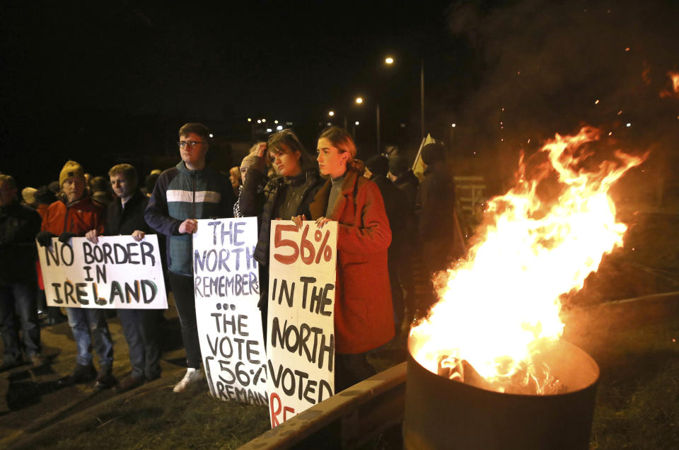 Protesters from the campaign group Border Communities Against Brexit take part in a demonstration in Carrickcarnon on the Irish border, Ireland, Friday, Jan. 31, 2020. Britain officially leaves the European Union on Friday after a debilitating political period that has bitterly divided the nation since the 2016 Brexit referendum. (AP Photo/Peter Morrison)