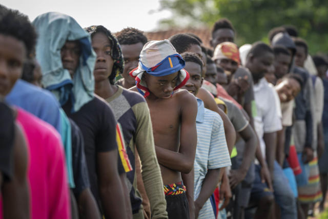 Haitians line up for breakfast at a campground being used to house a large group of Haitian migrants in Sierra Morena in Cuba's Villa Clara province, Thursday, May 26, 2022. A vessel carrying more than 800 Haitians trying to reach the United States wound up instead on the coast of central Cuba, in what appeared to be the largest group seen yet in a swelling exodus from crisis-stricken Haiti. (AP Photo Ramon Espinosa)