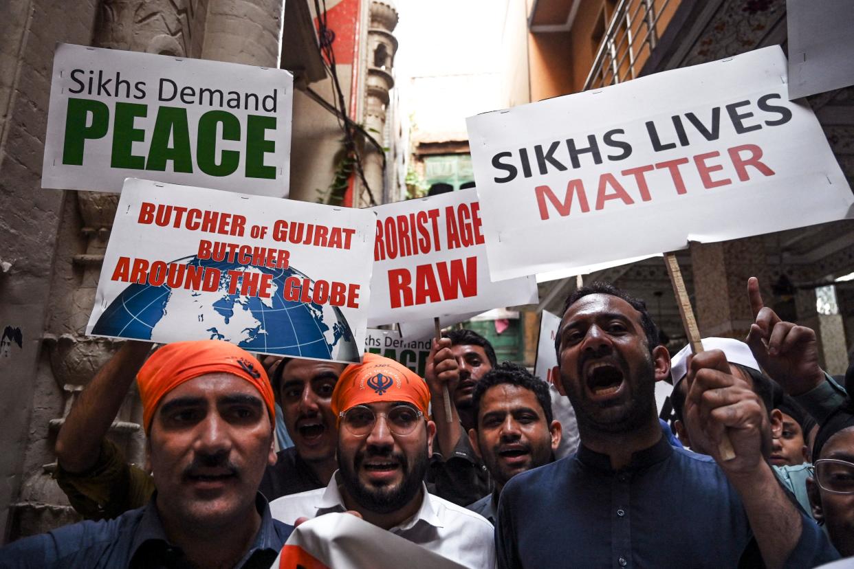 Protesters carry signs reading: Sikhs demand peace and Sikhs lives matter