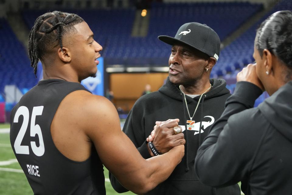 Mar 2, 2024; Indianapolis, IN, USA; NFL Hall of Fame player Jerry Rice talks to his son, Southern California wide receiver Brenden Rice (WO25) during the 2024 NFL Combine at Lucas Oil Stadium. Mandatory Credit: Kirby Lee-USA TODAY Sports