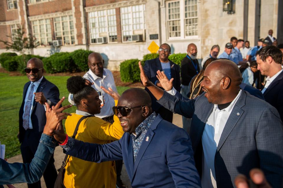 Members of the community and the Million Fathers March group greet students at Lanier High School in Montgomery on Wednesday.
(Photo: Jake Crandall/ Advertiser)