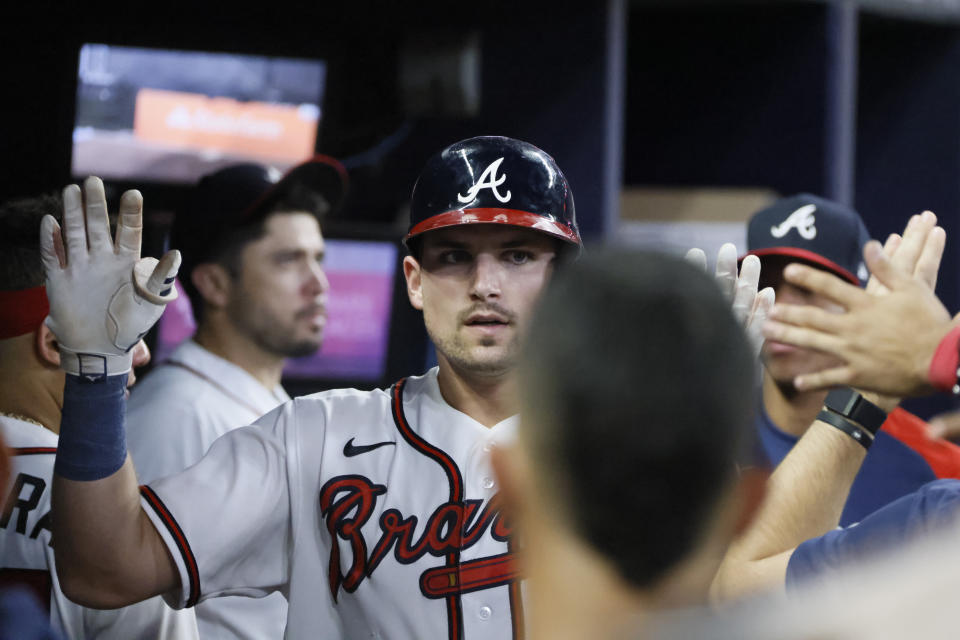 Atlanta Braves' Austin Riley is congratulated after hitting a solo home run in the fourth inning of a baseball game against the Miami Marlins, Saturday, Sept. 3, 2022, in Atlanta. (AP Photo/Bob Andres)