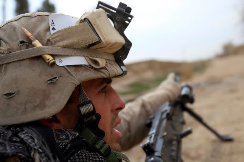 FILE PHOTO: U.S. Marine gestures during an operation in Marjah, Helmand province