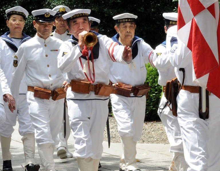 War veterans and others wearing uniforms of the Imperial Navy march at the Yasukuni shrine to honour the dead on the 67th anniversary of Japan's surrender from World War II in Tokyo. China and South Korea have pressed Japan to face up to its wartime past, as festering territorial disputes flared and Asia marked the anniversary of Tokyo's World War II surrender