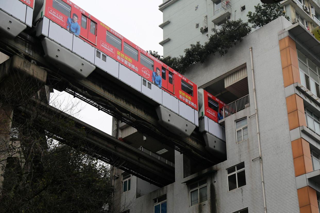 The Chongqing Rail passes right through a residential building: FEATURE CHINA/GETTY IMAGES