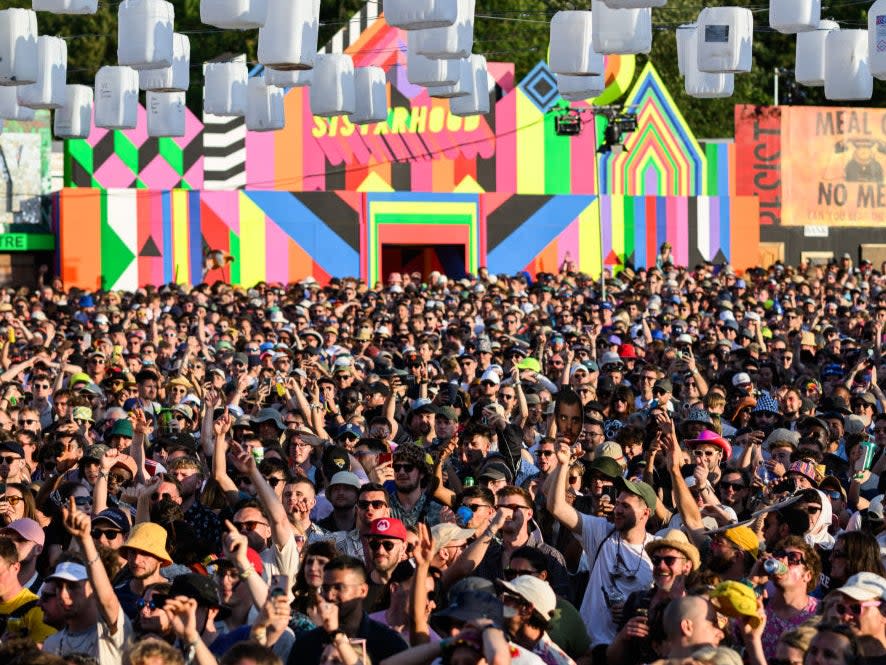 Festival-goers listen to Mike Skinner perform on Day 2 of Glastonbury Festival 2023 (Getty Images)