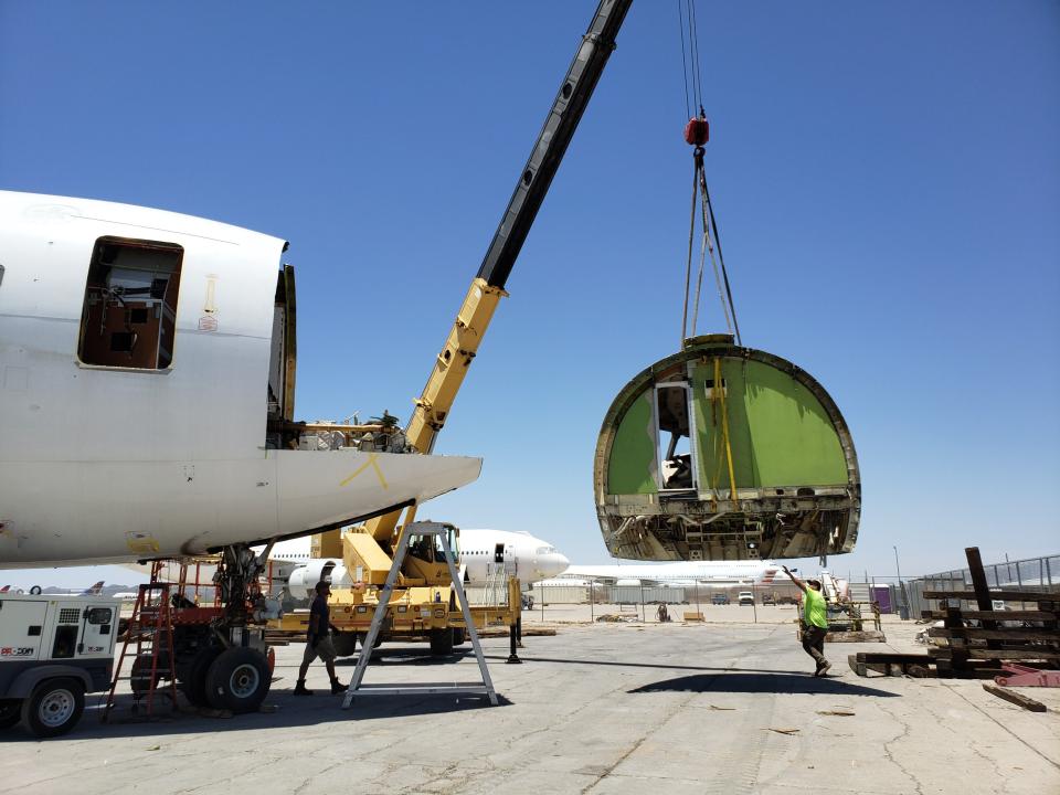 Ascent Aviation Services employees working on a plane in reclamation.