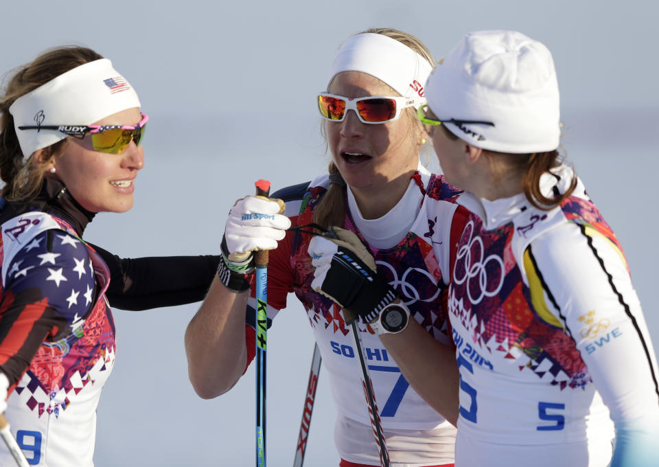 Norway's Astrid Uhrenholdt Jacobsen, center, is comforted by United States' Sophie Caldwell, left, and Sweden's Ida Ingemarsdotter, right, after the women's final of the cross-country sprint at the 2014 Winter Olympics, Tuesday, Feb. 11, 2014, in Krasnaya Polyana, Russia. (AP Photo/Matthias Schrader)