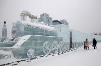 <span><b>10th most popular.</b><br>Visitors walk past a train-shaped ice sculpture ahead of the 31st Harbin International Ice and Snow Festival in the northern city of Harbin, Heilongjiang province, January 4, 2015. (REUTERS/Kim Kyung-Hoon)</span>