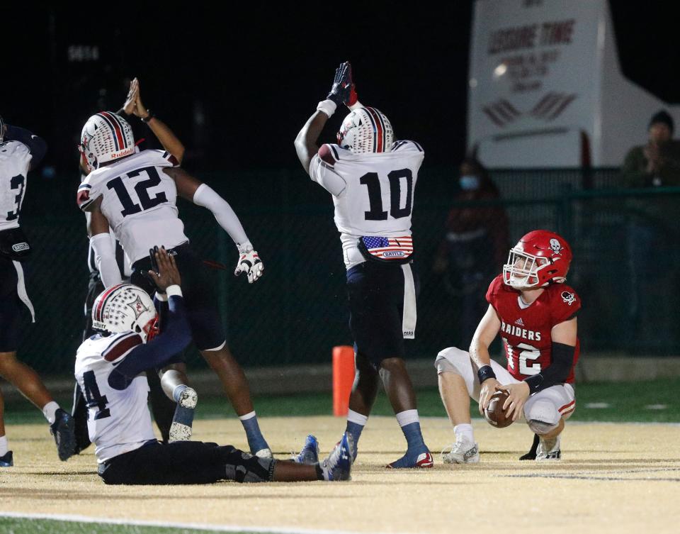 Savannah Christian quarterback Paulus Zittrauer watches as the Sandy Creek defense celebrates after sacking him for a safety during Friday's game at Pooler Stadium.