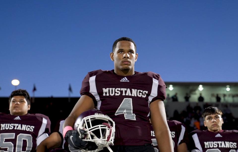 Nick Burgess and the Clifton Mustangs stand for the playing of the National Anthem before their first game of the season on Oct. 2, 2020, in Clifton. 