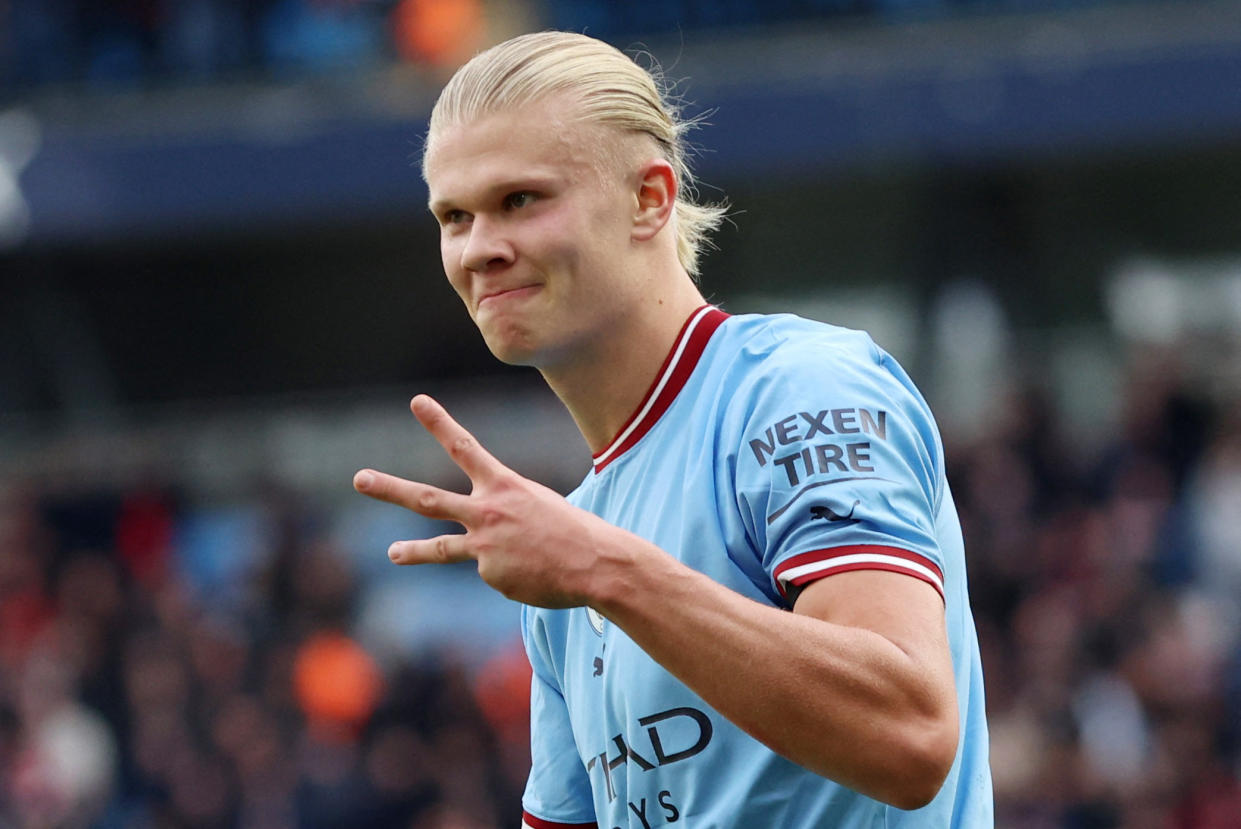 Manchester City's Erling Haaland holds up three fingers as he celebrates completing his hat-trick against Manchester United.