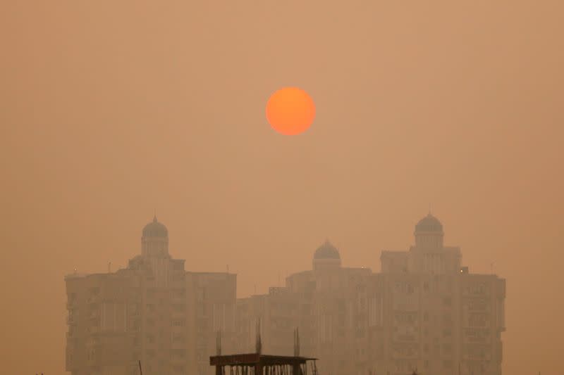 A residential building is seen shrouded in smog in Noida on the outskirts of New Delhi