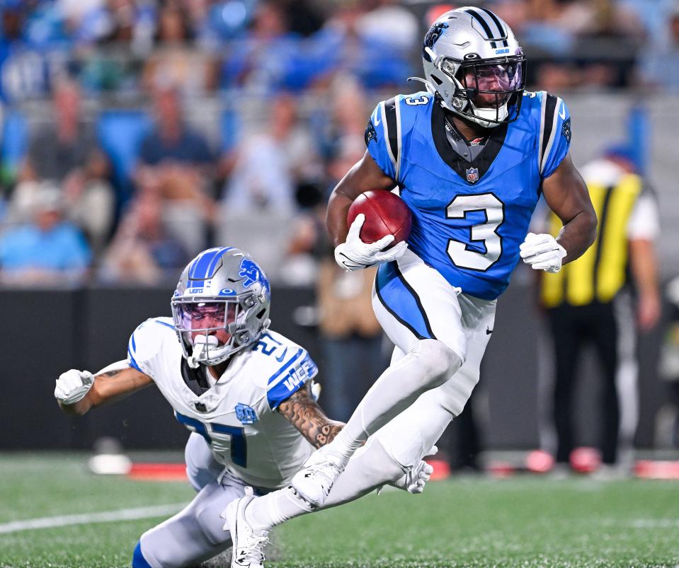 Detroit Lions cornerback Chase Lucas attempts to tackle Raheem Blackshear of the Carolina Panthers during the first half of a preseason game at Bank of America Stadium on August 25, 2023 in Charlotte, North Carolina.