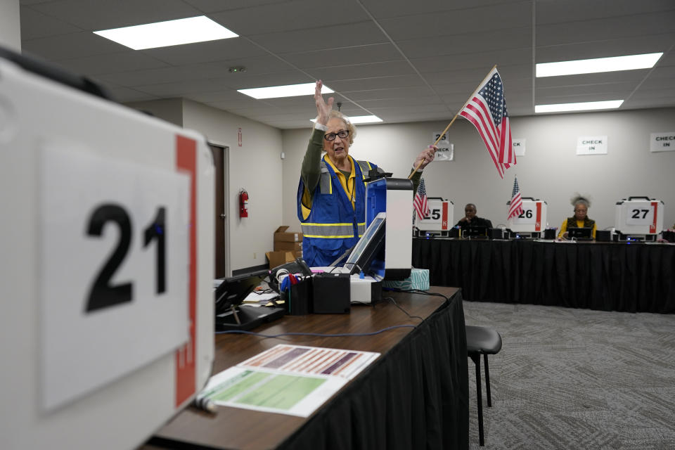 Poll worker Maxine Casada directs voters to the proper station during early in-person voting at the Hamilton County Board of Elections in Cincinnati, Wednesday, Oct. 11, 2023. (AP Photo/Carolyn Kaster)