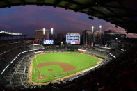 FILE - In this Oct. 7, 2018, file photo, ground crews prepare the field at Sun Trust Park, now known as Truist Park, ahead of Game 3 of MLB baseball's National League Division Series between the Atlanta Braves and the Los Angeles Dodgers in Atlanta. Truist Park lost the 2021 All-Star Game on Friday, April 2, 2021, when Major League Baseball decided to move the game elsewhere over the league’s objection to Georgia’s sweeping new election law that critics say restricts voting rights. (AP Photo/John Amis, File)