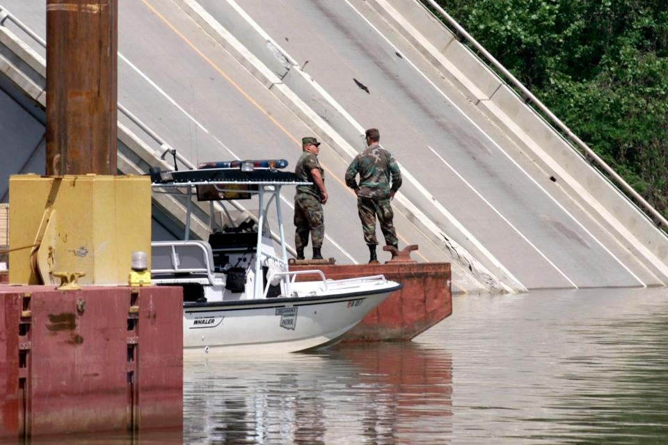 BRIDGE COLLAPSE, WEBBERS FALLS, I-40, INTERSTATE 40, BARGE, HIT, COLLISION, DEATH, DEATHS, ARKANSAS RIVER:  Wreckage of Interstate 40 leads into the water on the West bank of the Arkansas river after a barge collided with a support on Sunday.