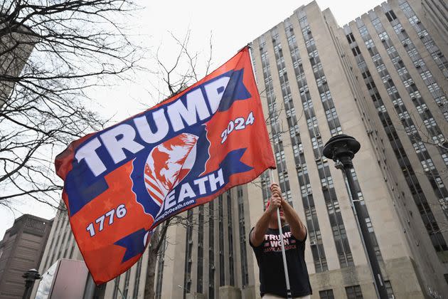 A supporter of Trump waves a banner in lower Manhattan.