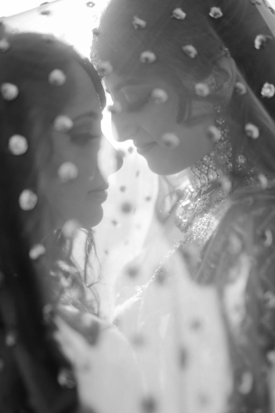 These two brides shared an intimate moment underneath a veil together.