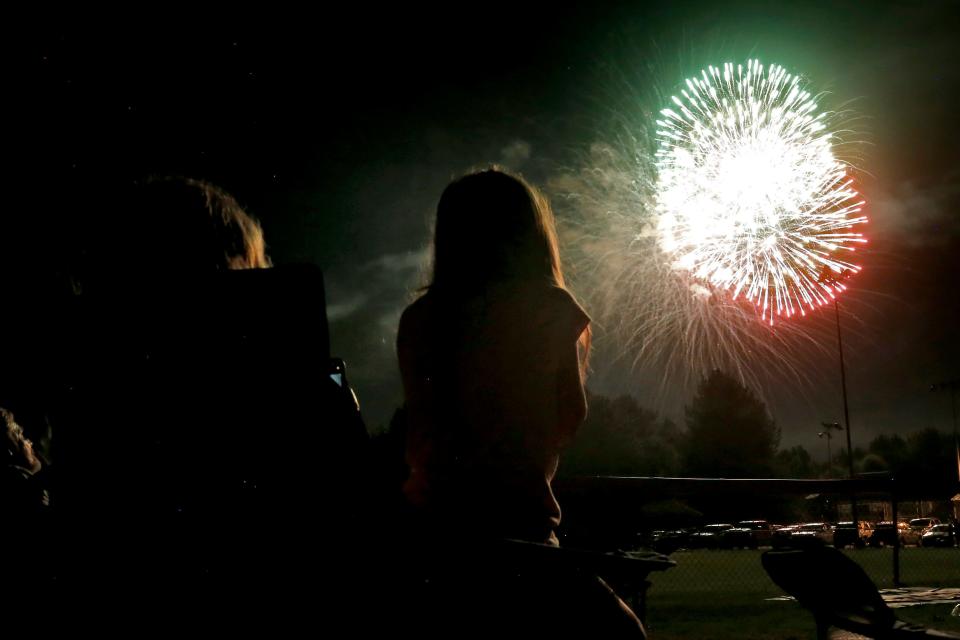 Locals watch fireworks explode in the air during the 2021 Star Spangled Classic in Athens on July 3, 2021.