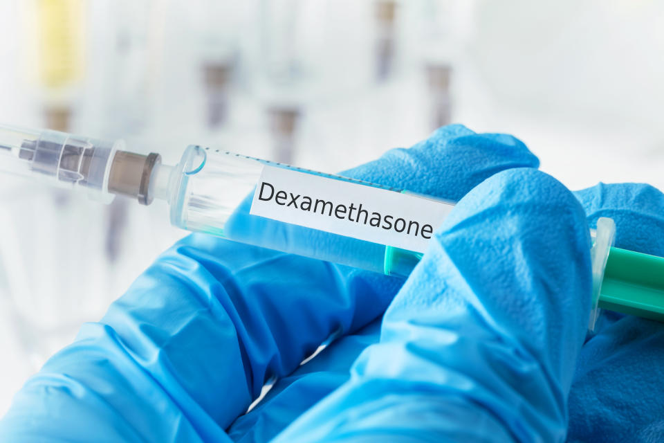 dexamethasone drug syringe in blue gloved hands