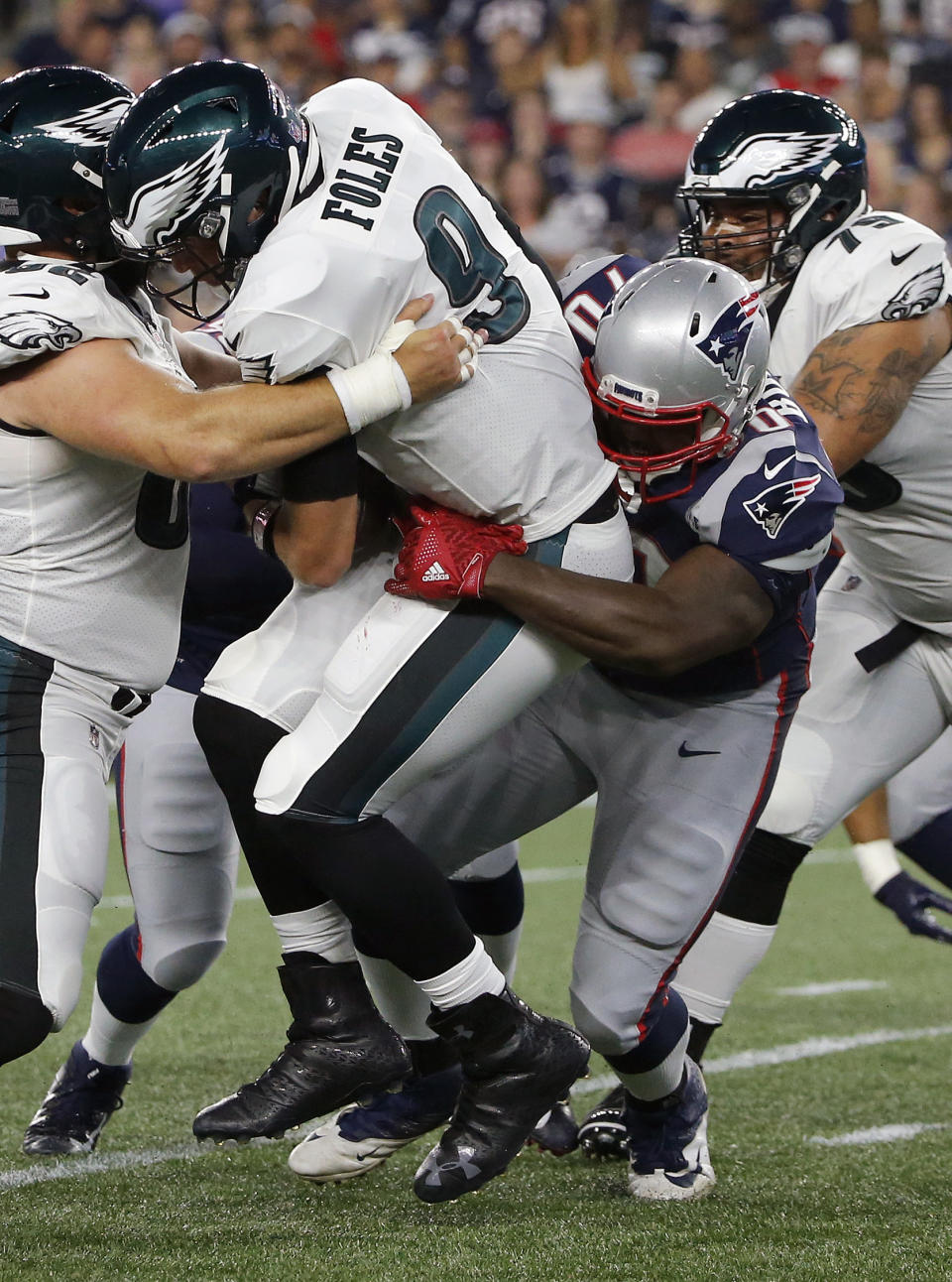 New England Patriots defensive tackle Adam Butler, right, sacks Philadelphia Eagles quarterback Nick Foles during the first half of a preseason NFL football game, Thursday, Aug. 16, 2018, in Foxborough, Mass. (AP Photo/Mary Schwalm)