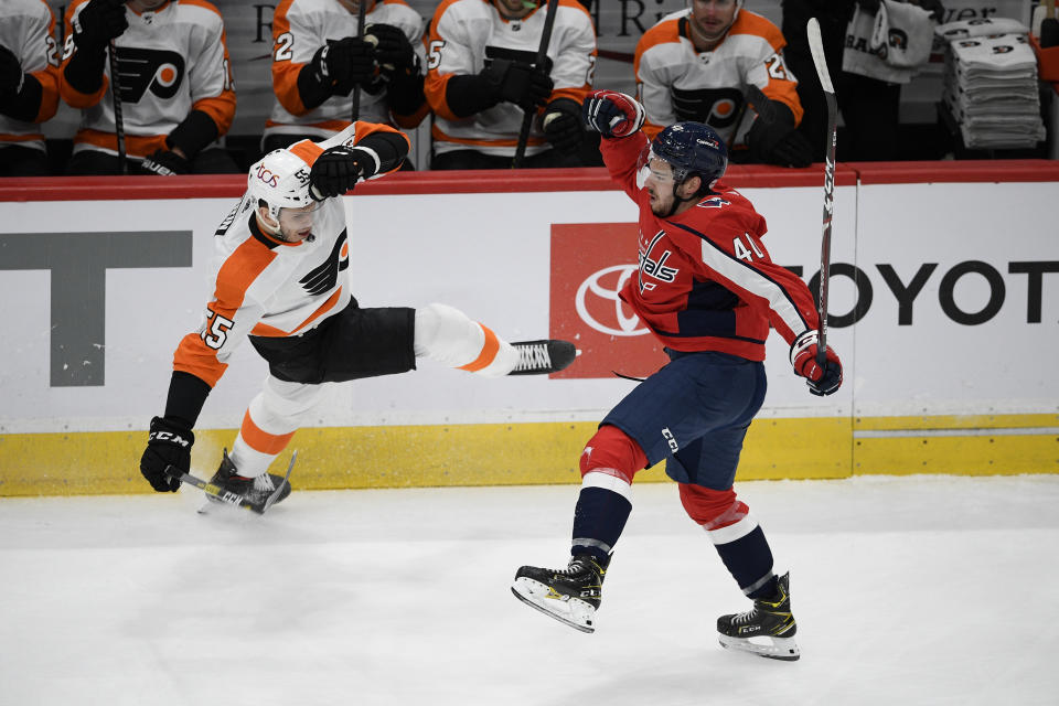 Washington Capitals center Garrett Pilon (40) and Philadelphia Flyers left wing Samuel Morin (55) lose their balance after colliding during the first period of an NHL hockey game Saturday, May 8, 2021, in Washington. (AP Photo/Nick Wass)