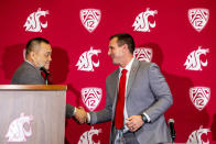 Washington State athletic director Pat Chun, left, shakes hands with Jake Dickert, the university's new football coach, Thursday, Dec. 2, 2021, in Pullman, Wash. Dickert was elevated last week from interim coach after the Cougars pounded rival Washington 40-13 in the annual Apple Cup game in Seattle. (August Frank/Lewiston Tribune via AP)