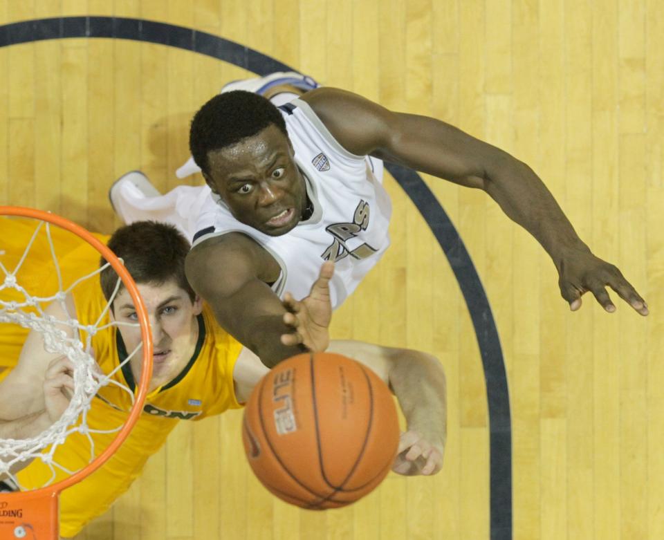 University of Akron's Demetrius Treadwell (right) goes up for a rebound against North Dakota State's Chris Kading at Rhodes Arena on Feb. 22, 2013.