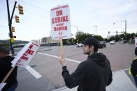 Boeing Machinists Union member Andrei Cojocaru waves at passing traffic from the picket line at the Renton assembly plant, Friday, Sept. 13, 2024, in Renton, Wash. (AP Photo/John Froschauer)